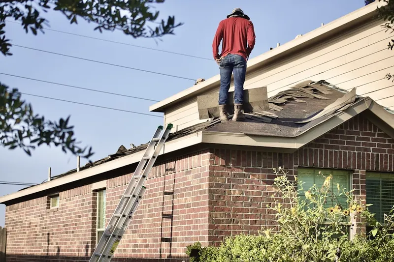 Professional roofer working on a residential roof in Key Biscayne